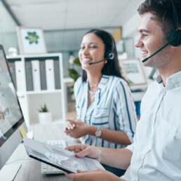 Call center, computer and team with document for customer service, crm and telemarketing in office