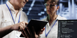 two people reviewing software on a tablet