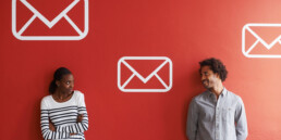 two people standing next to email icons