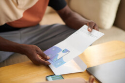 man opening up direct mail letter