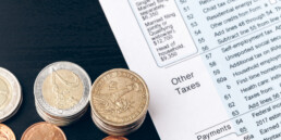 tax forms with coins