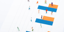 High angle view of people figures on surface with blue and orange diagram isolated on white,